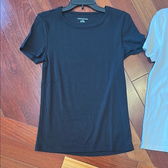 Women large Amazon tops in white and black. One top has a wider neckline. - Picture 4 of 14